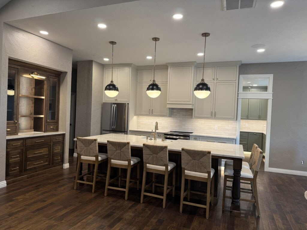 View of the kitchen island transitioning into a dining area, showing the open-concept layout and natural light flooding the space.