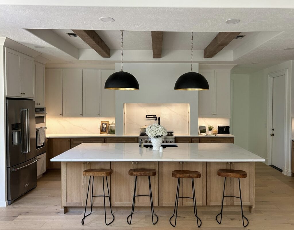 View of the kitchen island transitioning into a dining area, showing the open-concept layout and natural light flooding the space